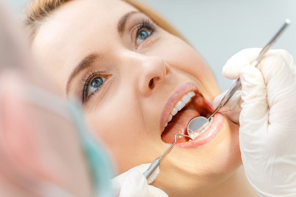 close up photo of a woman during a dental examination